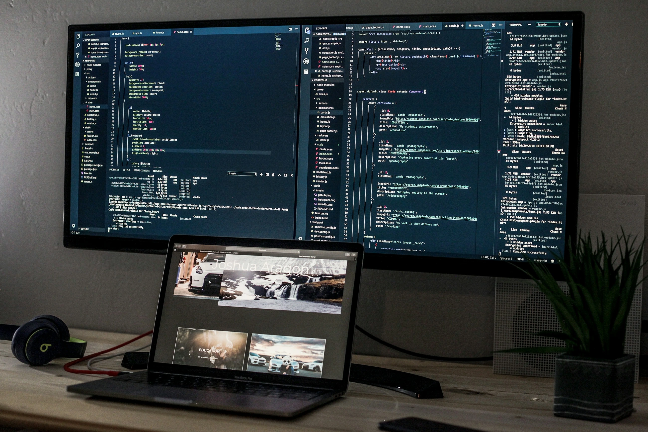 A development workstation with a laptop and screens displaying code.