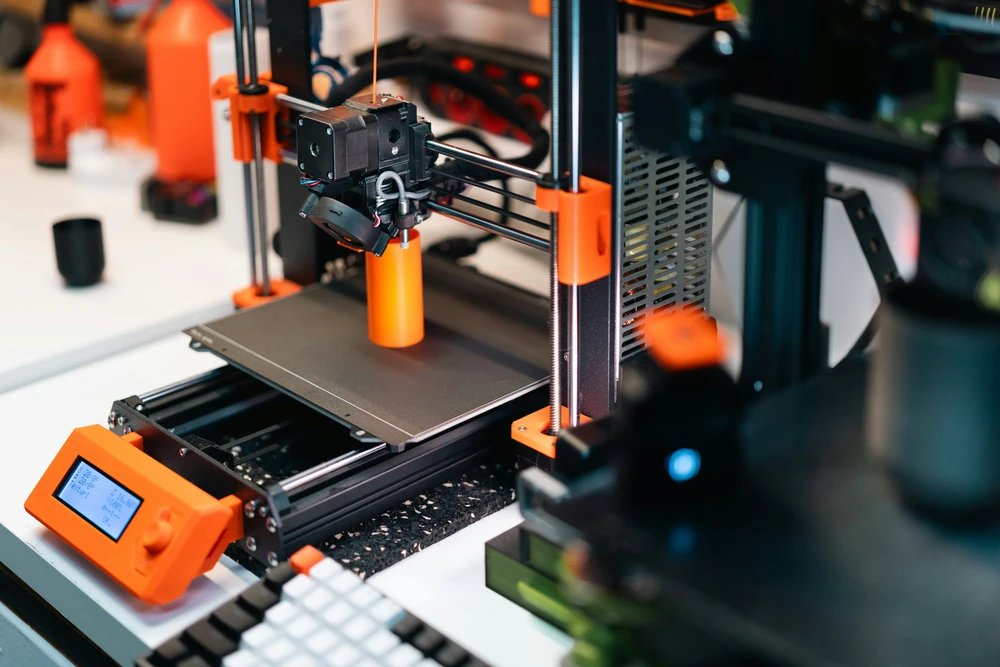 A 3D printer produces a physical prototype.
