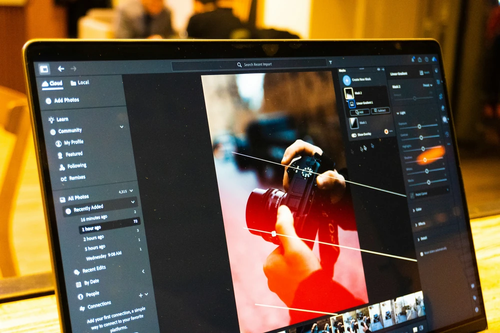 A laptop with image-editing software displayed on the screen.