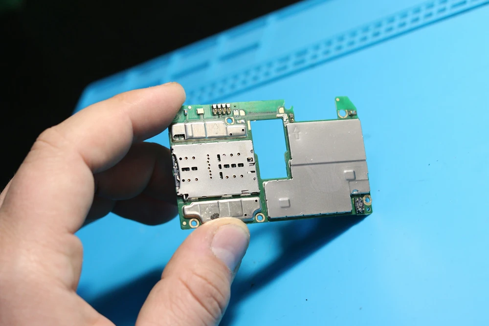 A circuit board is being examined during technical testing.