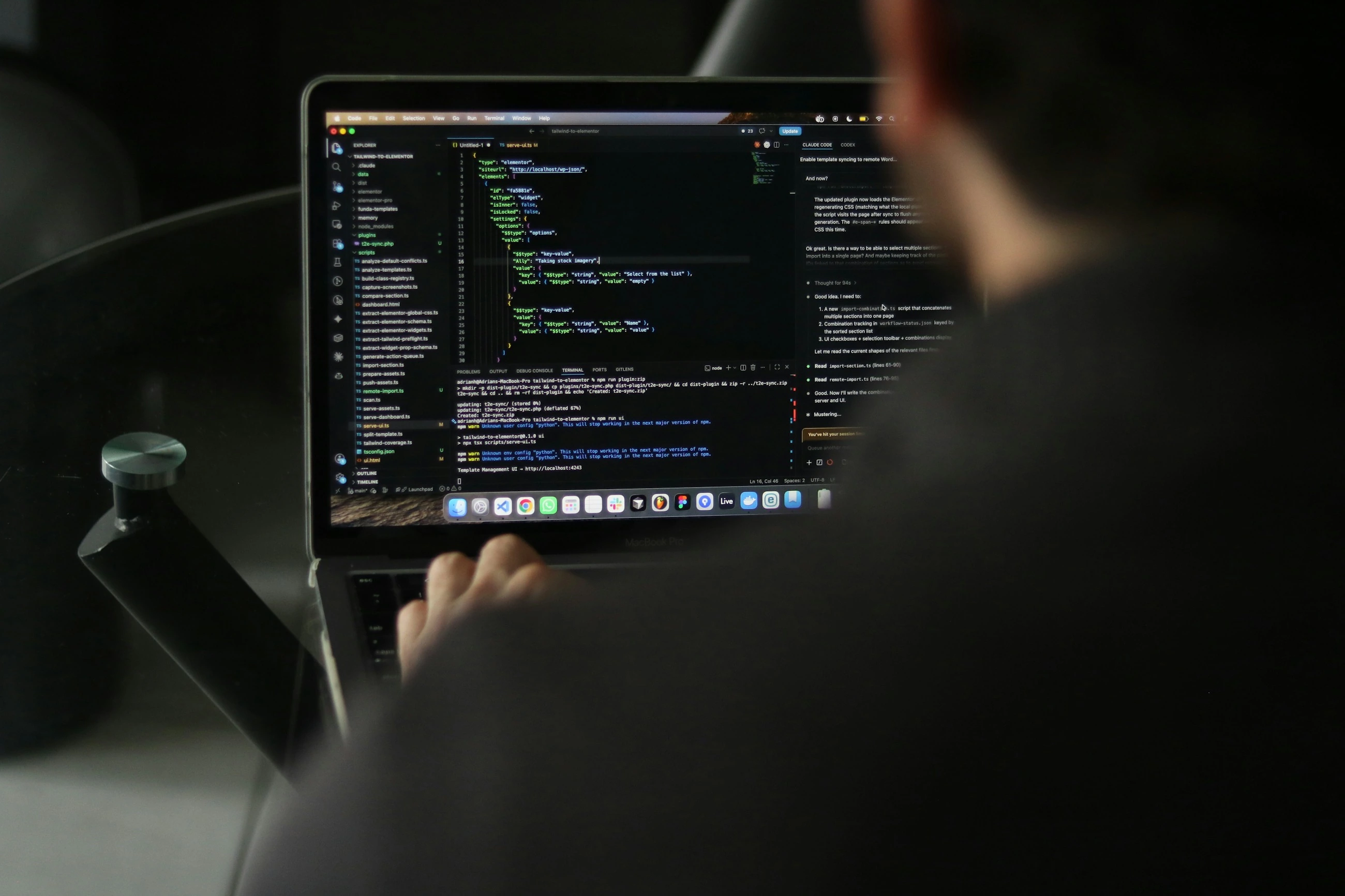 A developer works with source code and development tools on a laptop.