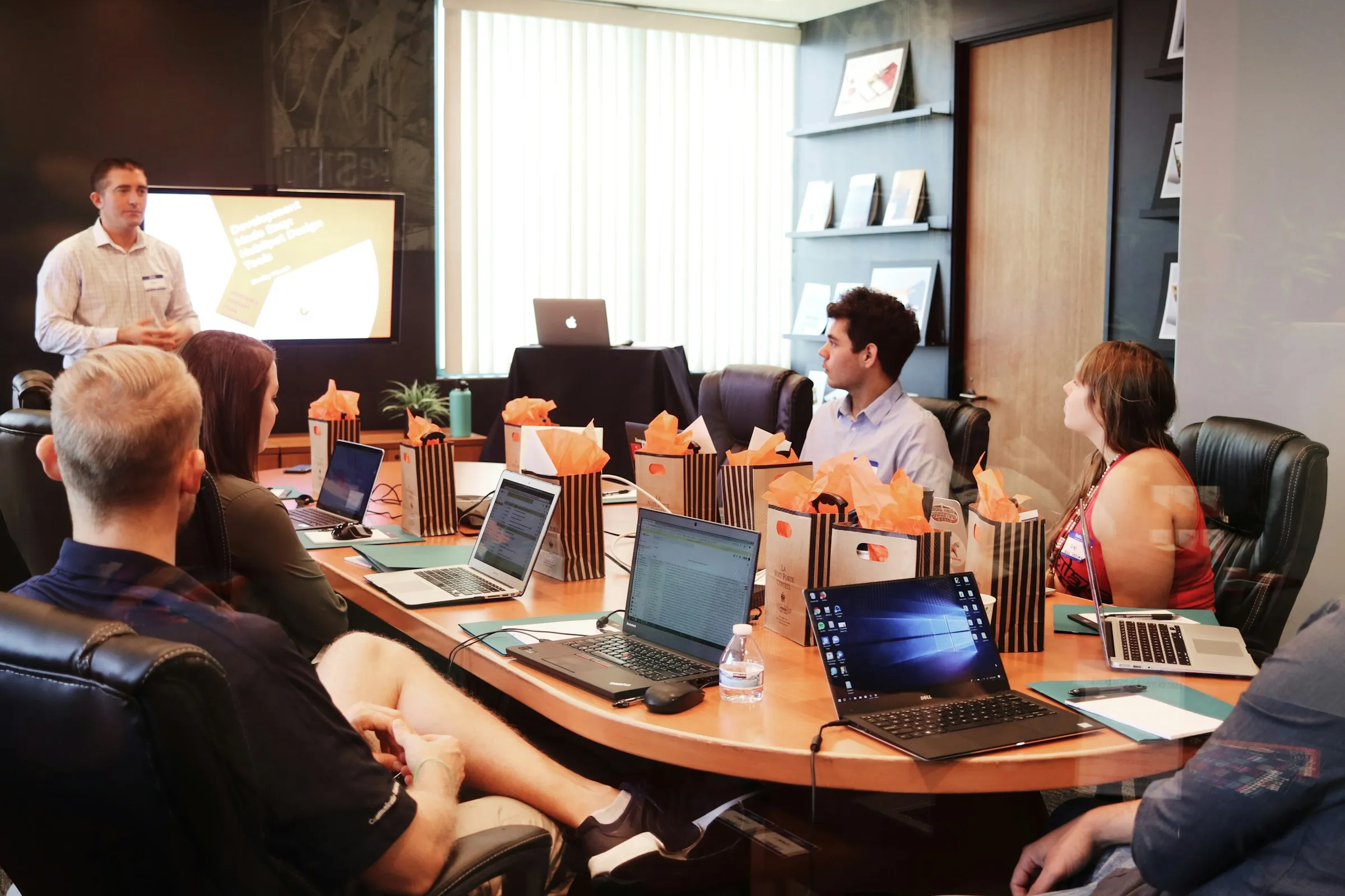 Colleagues discuss information around a conference table